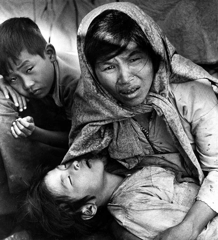 Vietnamese Mother Nguyen Thi Yen Holds Her Sick Child As She